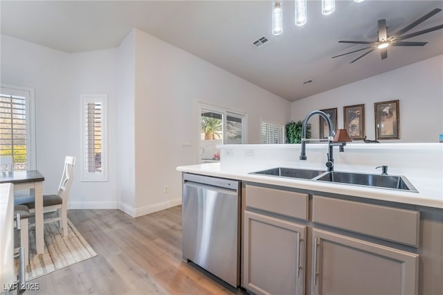 kitchen with stainless steel dishwasher, a healthy amount of sunlight, gray cabinetry, and sink