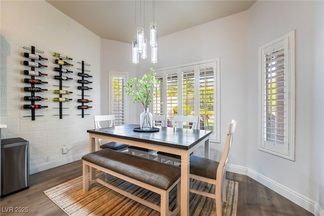 dining room featuring dark hardwood / wood-style floors and an inviting chandelier