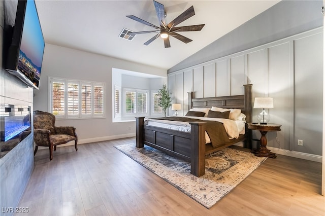 bedroom featuring ceiling fan, light hardwood / wood-style flooring, and lofted ceiling