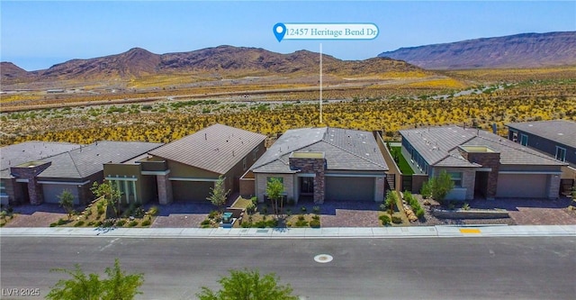 view of front facade with a mountain view and a garage