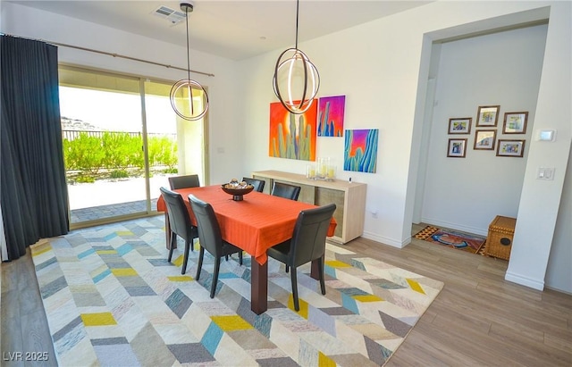 dining area with light hardwood / wood-style floors