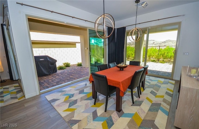 dining area featuring a mountain view and wood-type flooring