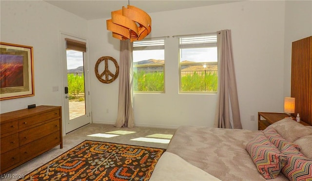 bedroom featuring access to outside and light carpet