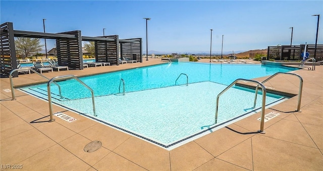 view of swimming pool with a patio