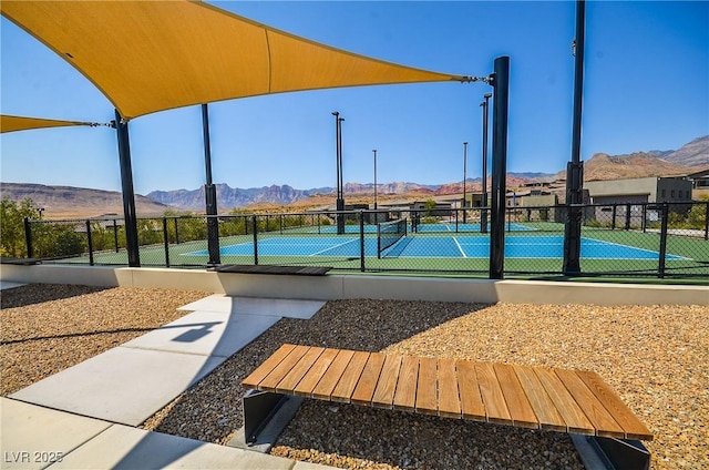 view of tennis court featuring a mountain view