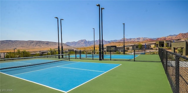 view of sport court featuring basketball hoop and a mountain view