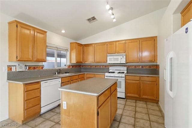 kitchen with white appliances, sink, vaulted ceiling, light tile patterned floors, and a kitchen island