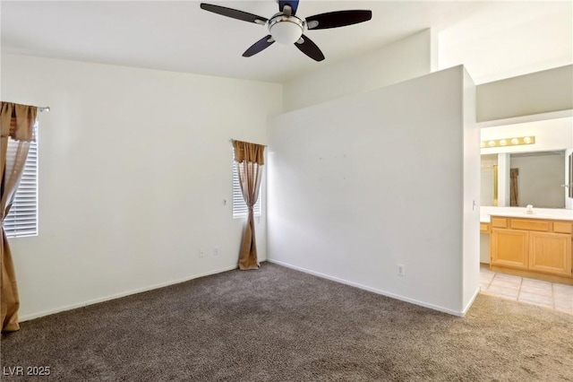 empty room featuring light colored carpet and ceiling fan