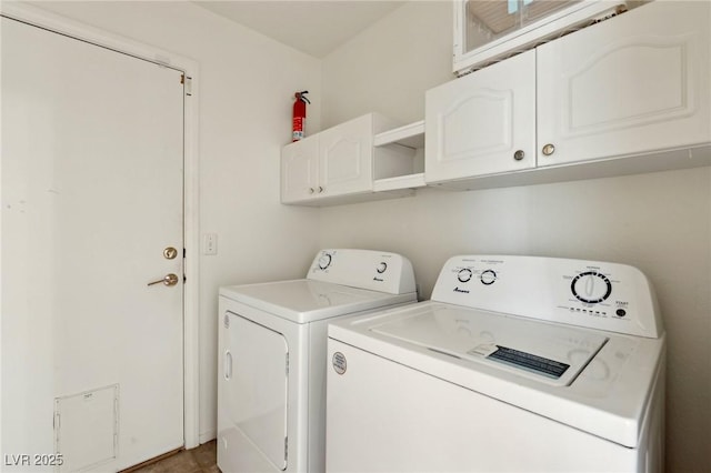 laundry area featuring washing machine and dryer and cabinets