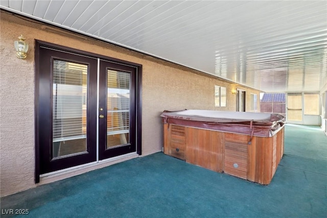 view of patio / terrace with french doors and a hot tub