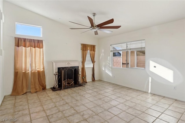 unfurnished living room with ceiling fan, plenty of natural light, a high end fireplace, and lofted ceiling