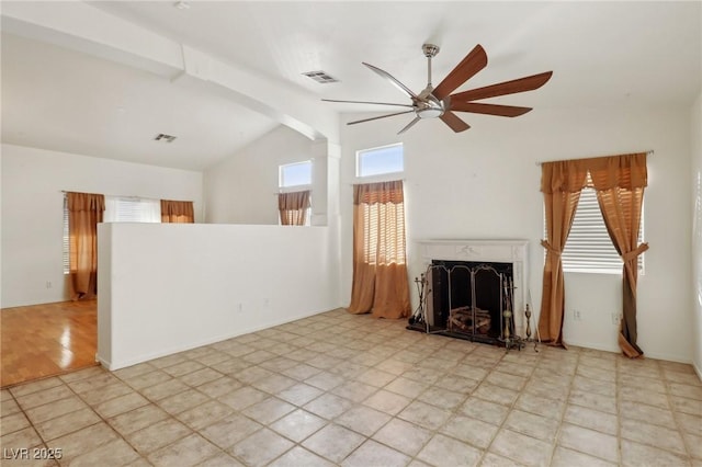 unfurnished living room with a wealth of natural light, ceiling fan, beamed ceiling, and high vaulted ceiling