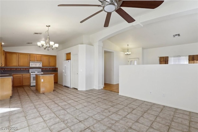 kitchen featuring lofted ceiling with beams, decorative light fixtures, white appliances, a kitchen island, and ceiling fan with notable chandelier