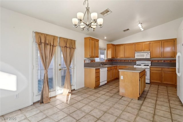 kitchen with a center island, a chandelier, vaulted ceiling, pendant lighting, and white appliances