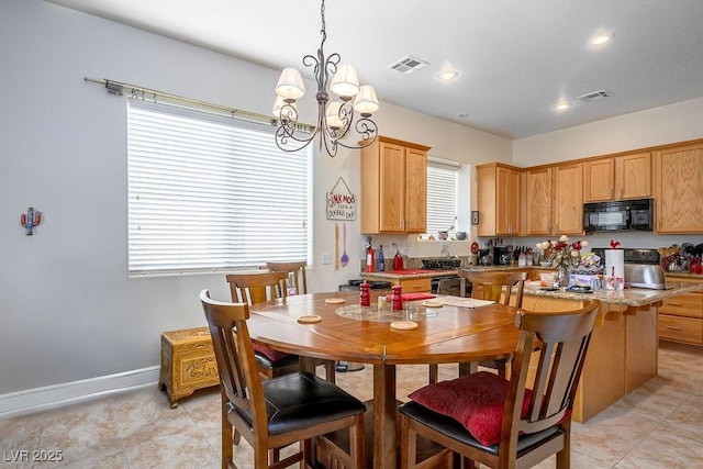 dining space with light tile patterned flooring and a notable chandelier