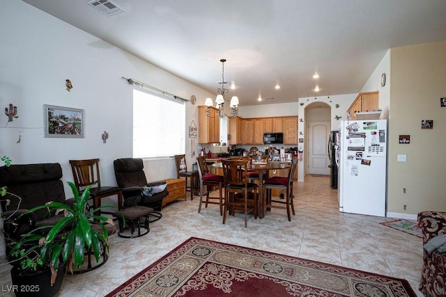 tiled dining space with a notable chandelier