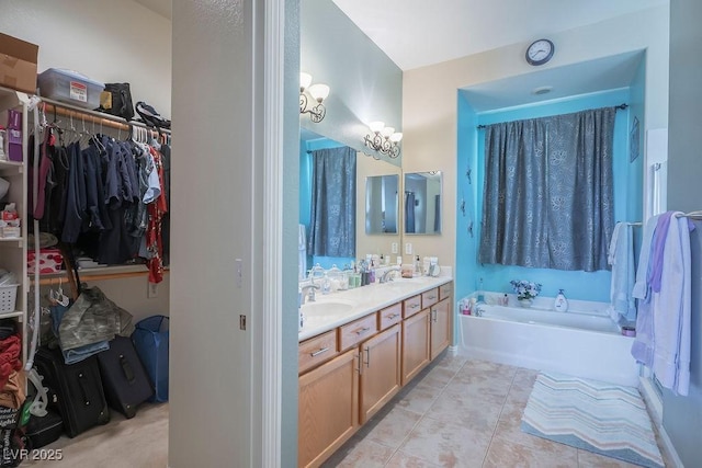 bathroom with tile patterned flooring, vanity, and a tub