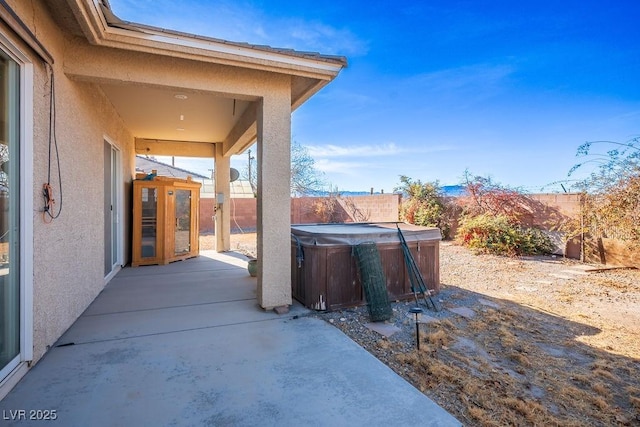 view of patio with a hot tub