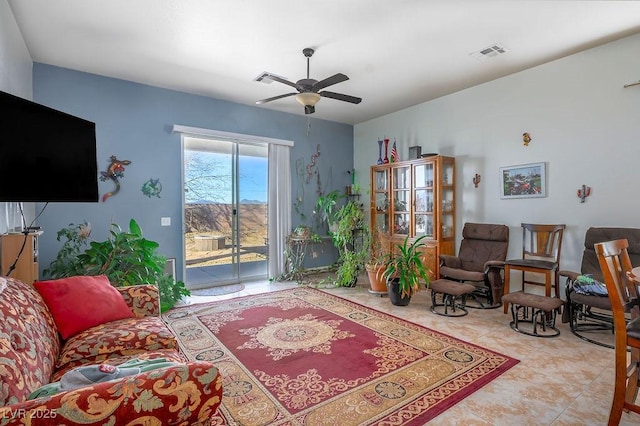 living room with ceiling fan and light tile patterned flooring