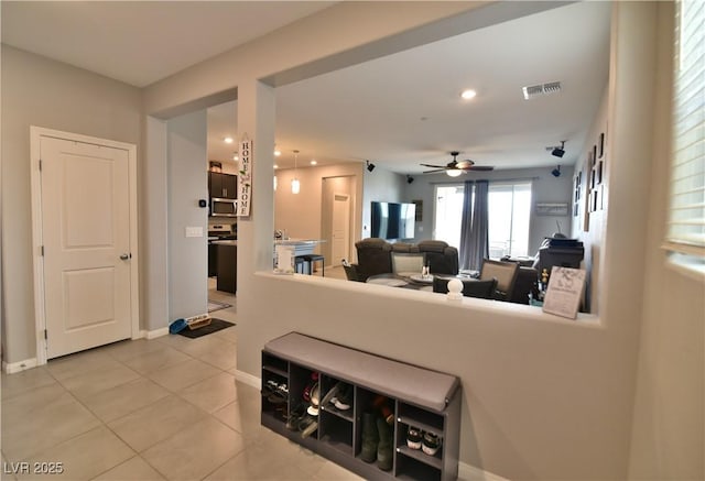 living room with tile patterned floors and ceiling fan