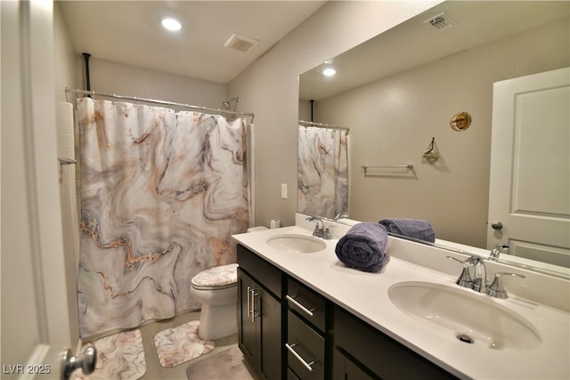 bathroom featuring a shower with shower curtain, vanity, toilet, and tile patterned floors