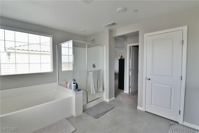 bathroom featuring tile patterned floors and independent shower and bath