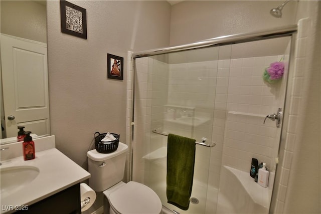 bathroom featuring vanity, toilet, and walk in shower