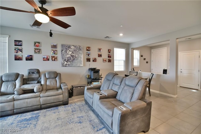 living room featuring ceiling fan and light tile patterned floors