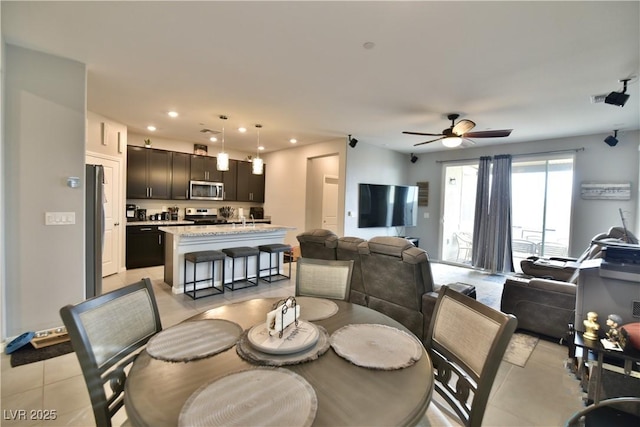 dining area with ceiling fan and light tile patterned flooring