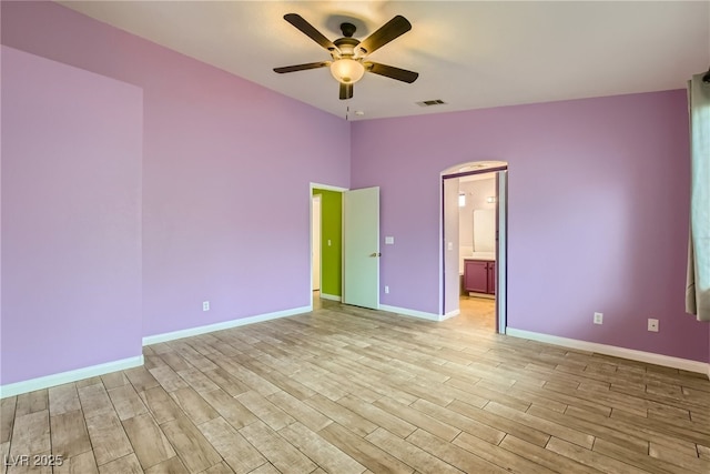 unfurnished bedroom featuring ensuite bath and ceiling fan