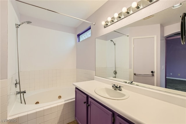 bathroom with vanity and tiled bath