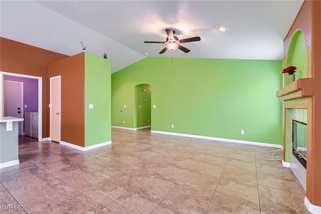 unfurnished living room with washer and clothes dryer, vaulted ceiling, and ceiling fan