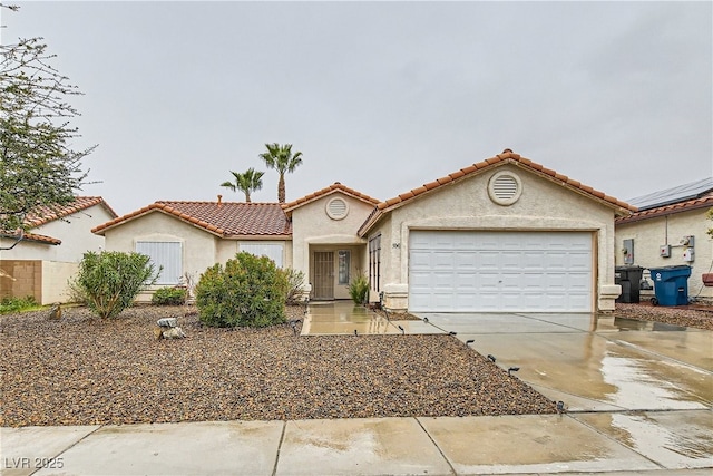 mediterranean / spanish-style home featuring a garage