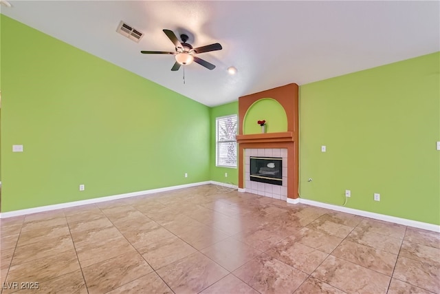 unfurnished living room featuring ceiling fan and a tile fireplace