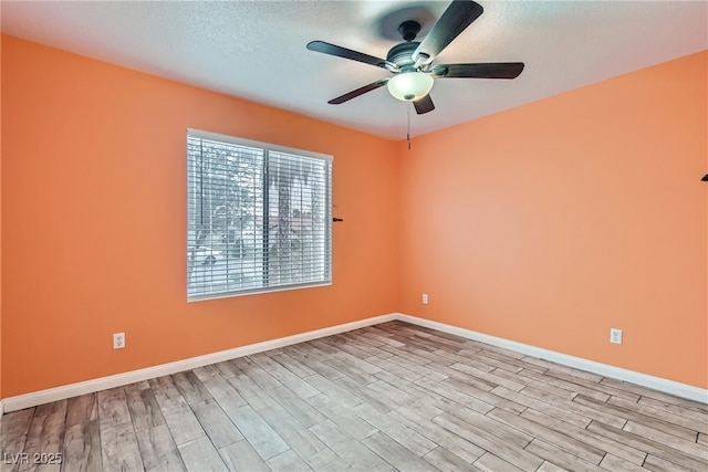 unfurnished room with ceiling fan and light wood-type flooring