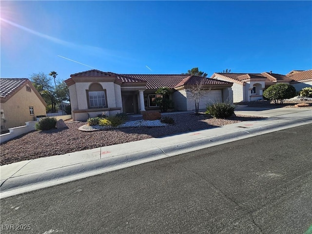 mediterranean / spanish house featuring a garage