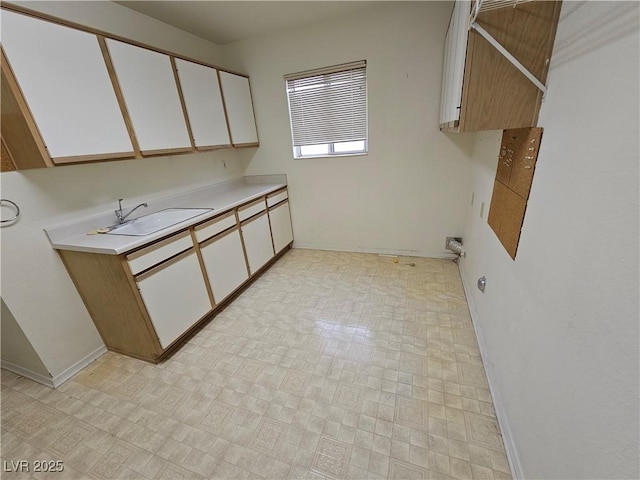 kitchen with white cabinetry and sink