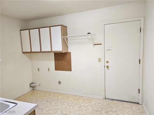 laundry area featuring gas dryer hookup and cabinets