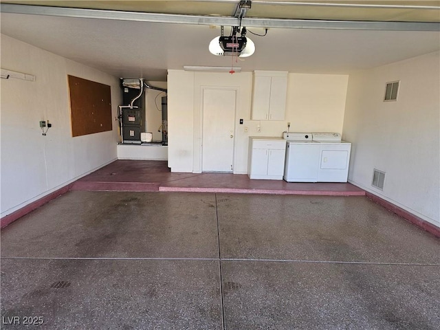 garage featuring washing machine and dryer and a garage door opener