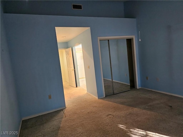 unfurnished bedroom featuring a closet and carpet floors