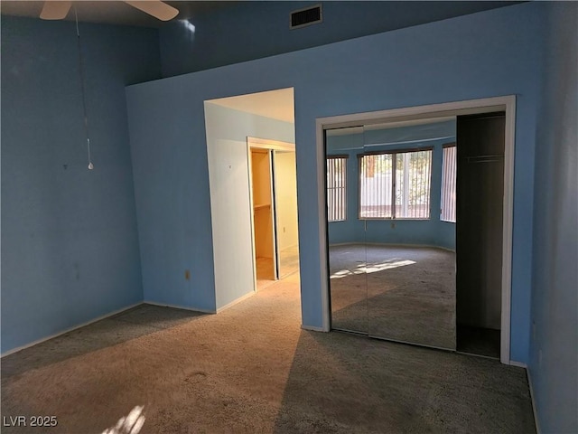 carpeted spare room with ceiling fan