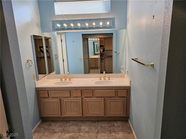 bathroom with tile patterned flooring and vanity