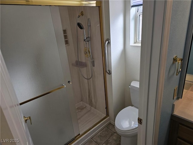 bathroom featuring tile patterned floors, toilet, an enclosed shower, and vanity