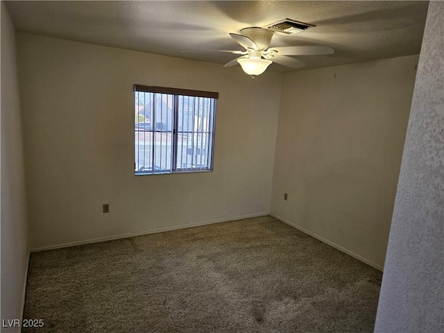 spare room with carpet floors and ceiling fan