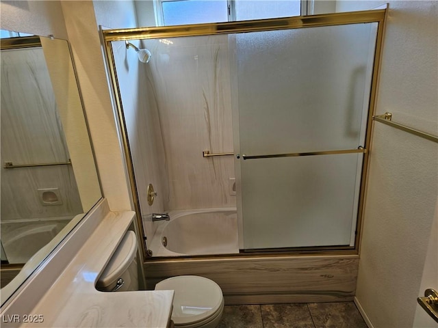 full bathroom with shower / bath combination with glass door, vanity, and toilet