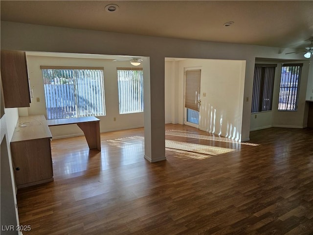 interior space with ceiling fan and dark hardwood / wood-style floors