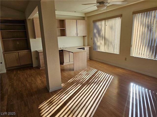 kitchen with dark hardwood / wood-style floors, a kitchen island, ceiling fan, and sink