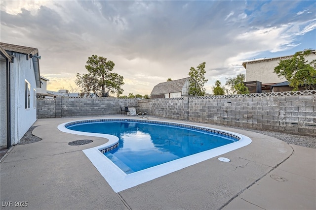 pool at dusk with a patio