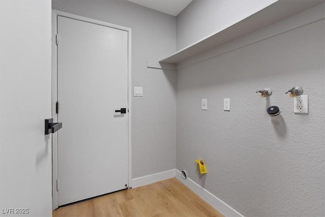 laundry area with gas dryer hookup and light wood-type flooring