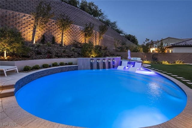 pool at dusk with a yard